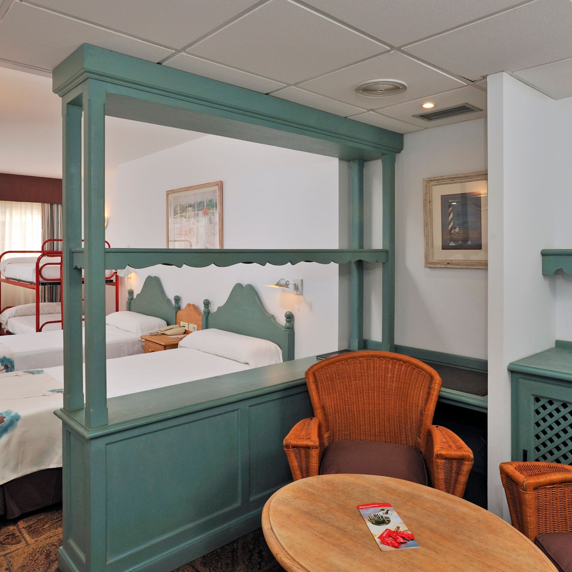 a room with two beds and a table