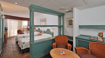 a room with two beds and a table