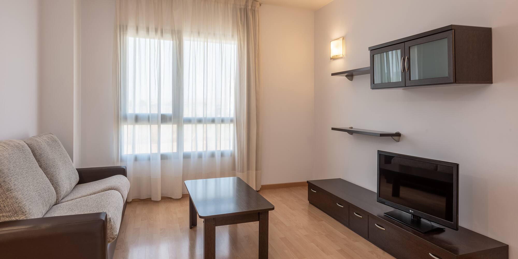 a living room with a couch and a tv