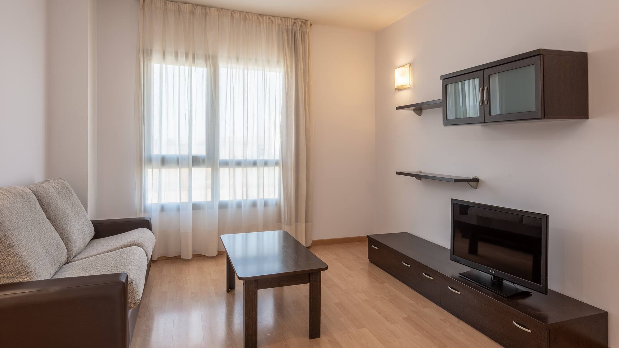 a living room with a couch and a tv