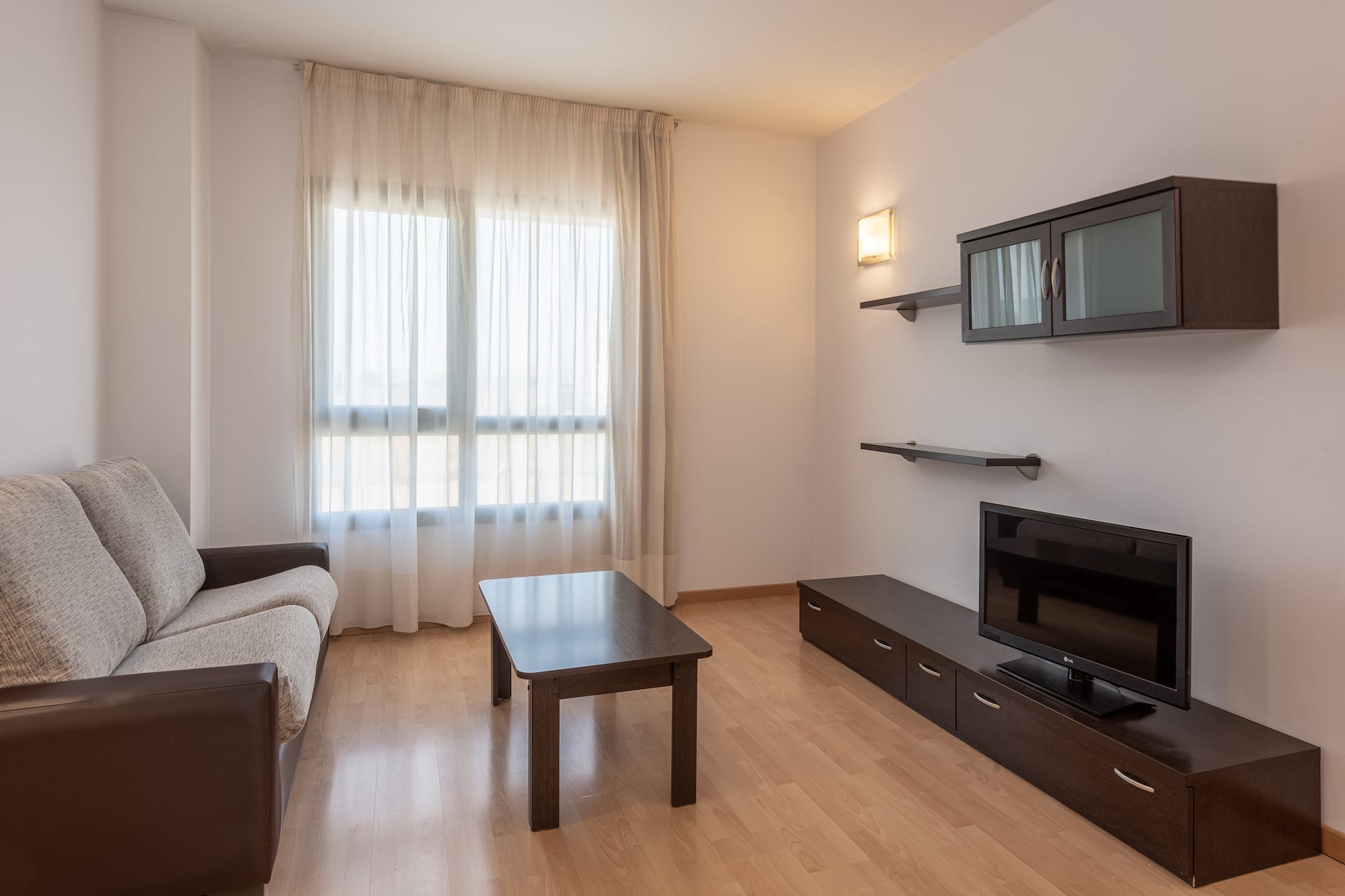 a living room with a couch and a tv