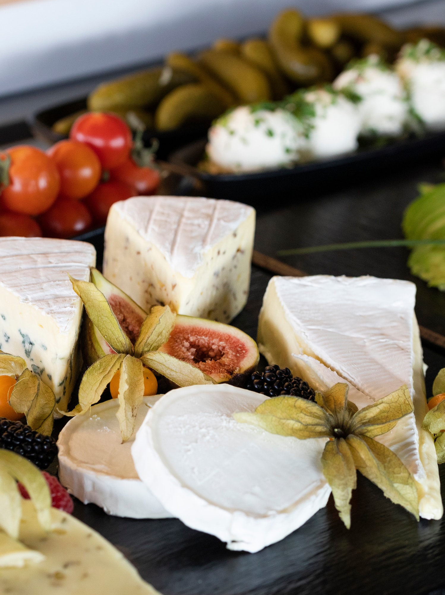 a plate of cheese and fruits