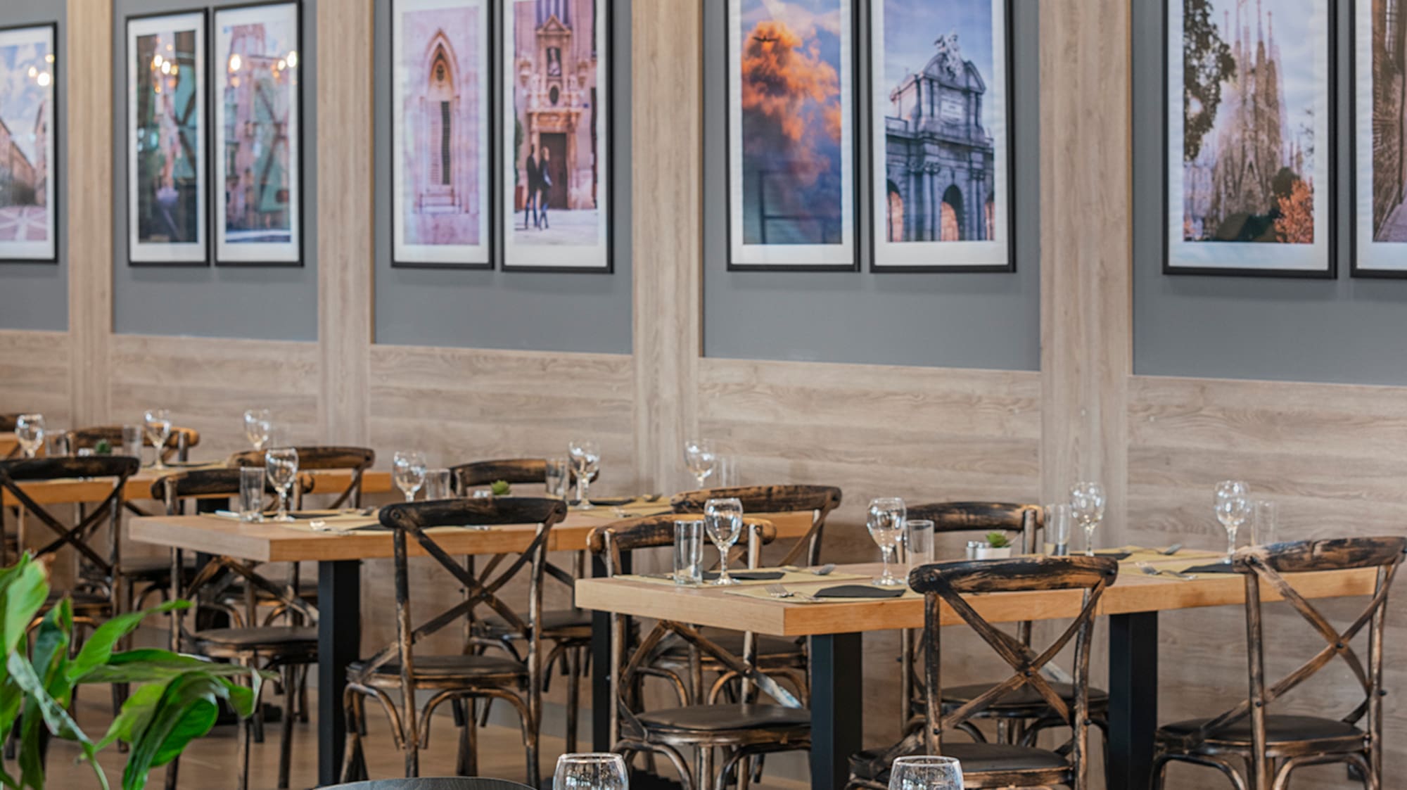 a room with tables and chairs and art on the wall