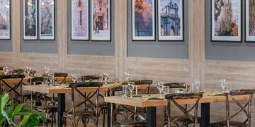 a room with tables and chairs and art on the wall