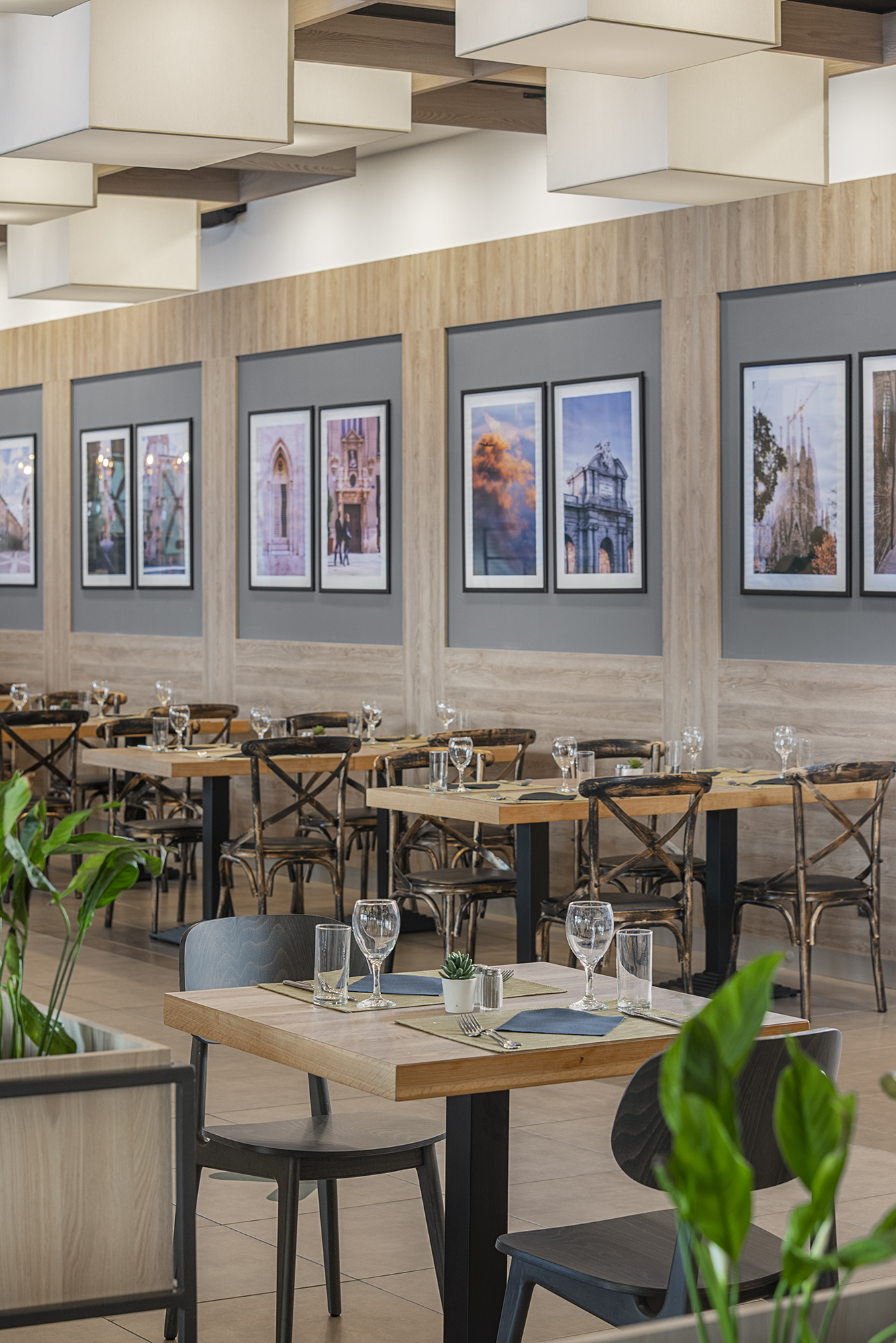 a room with tables and chairs and art on the wall