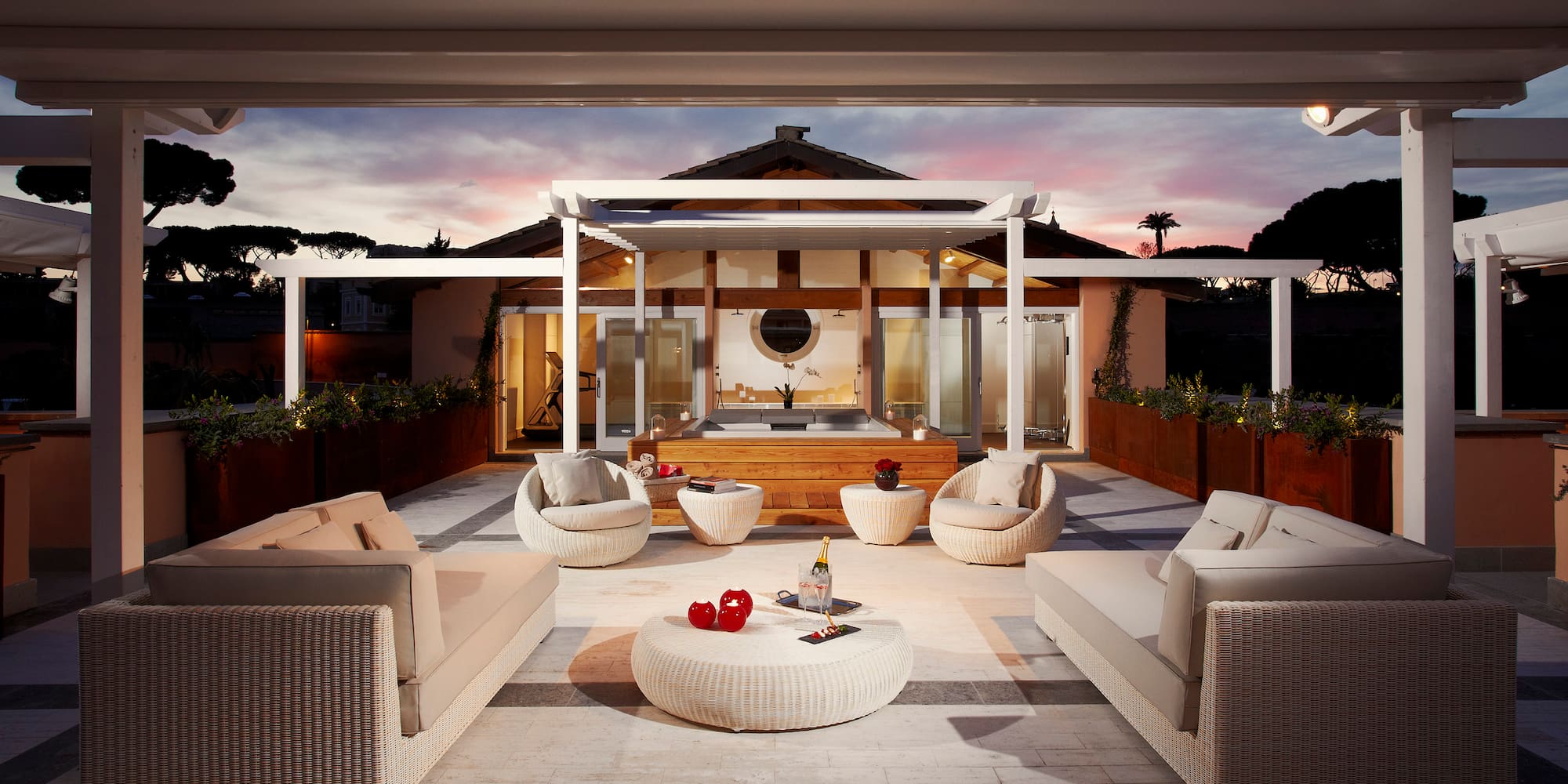 a patio with furniture and a hot tub