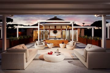 a patio with furniture and a hot tub