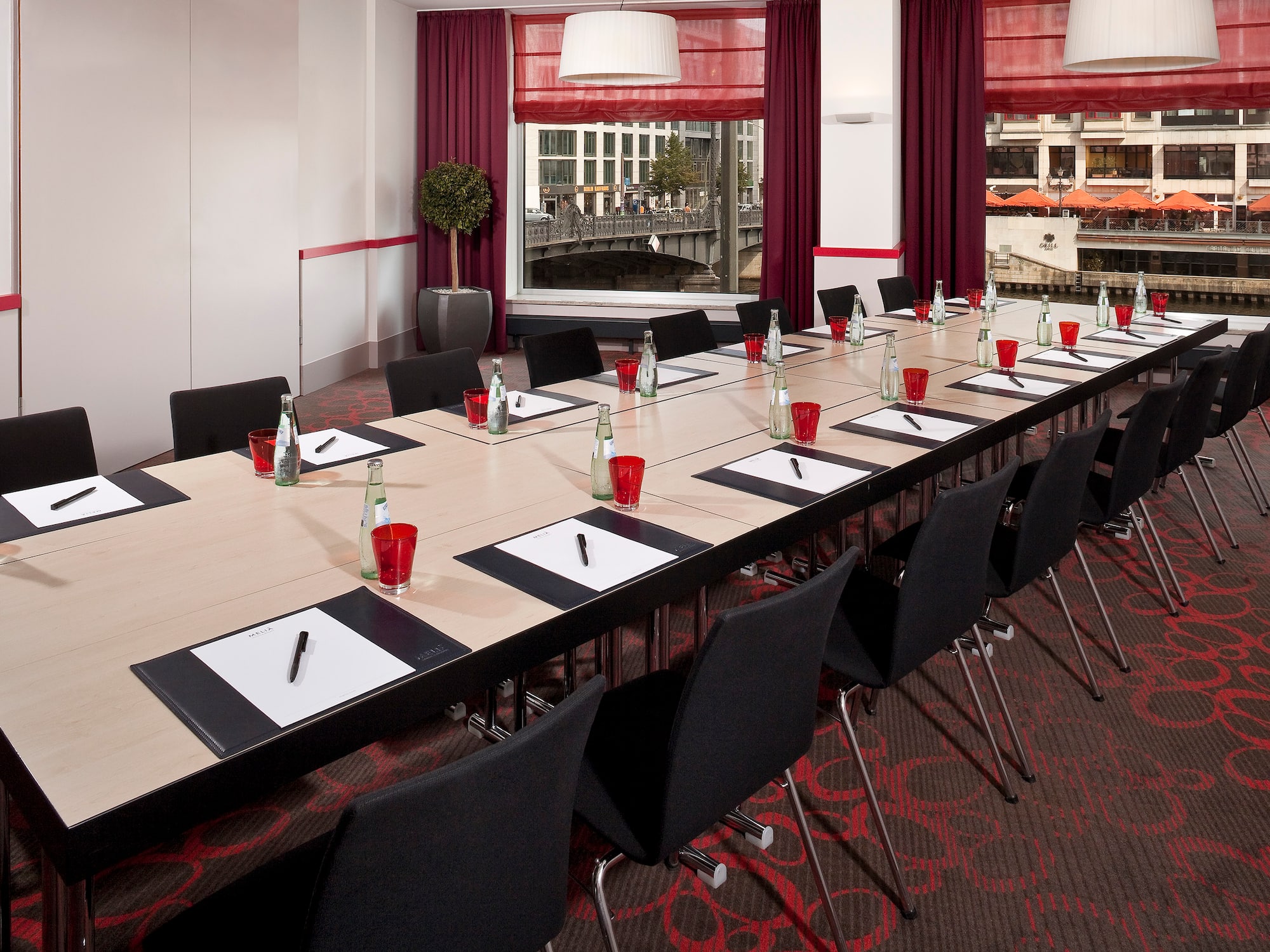 a long conference table with red cups and papers