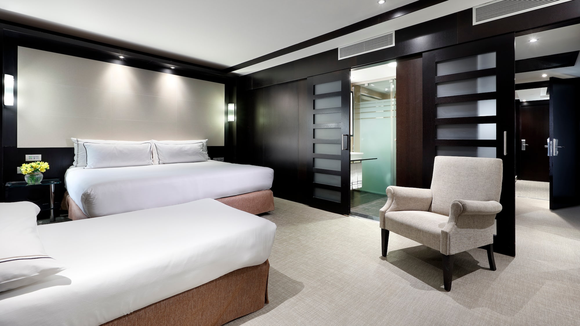 a room with two beds and a chair