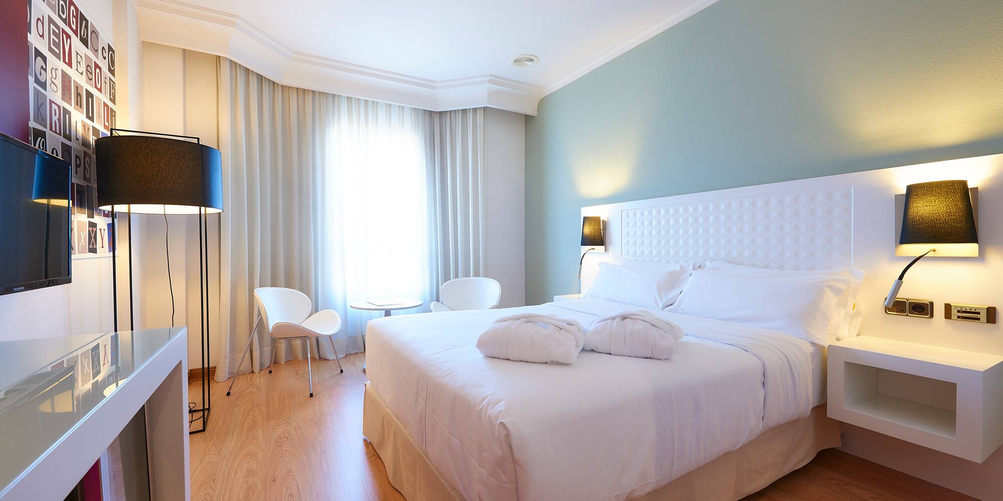 a bedroom with a bed and a table