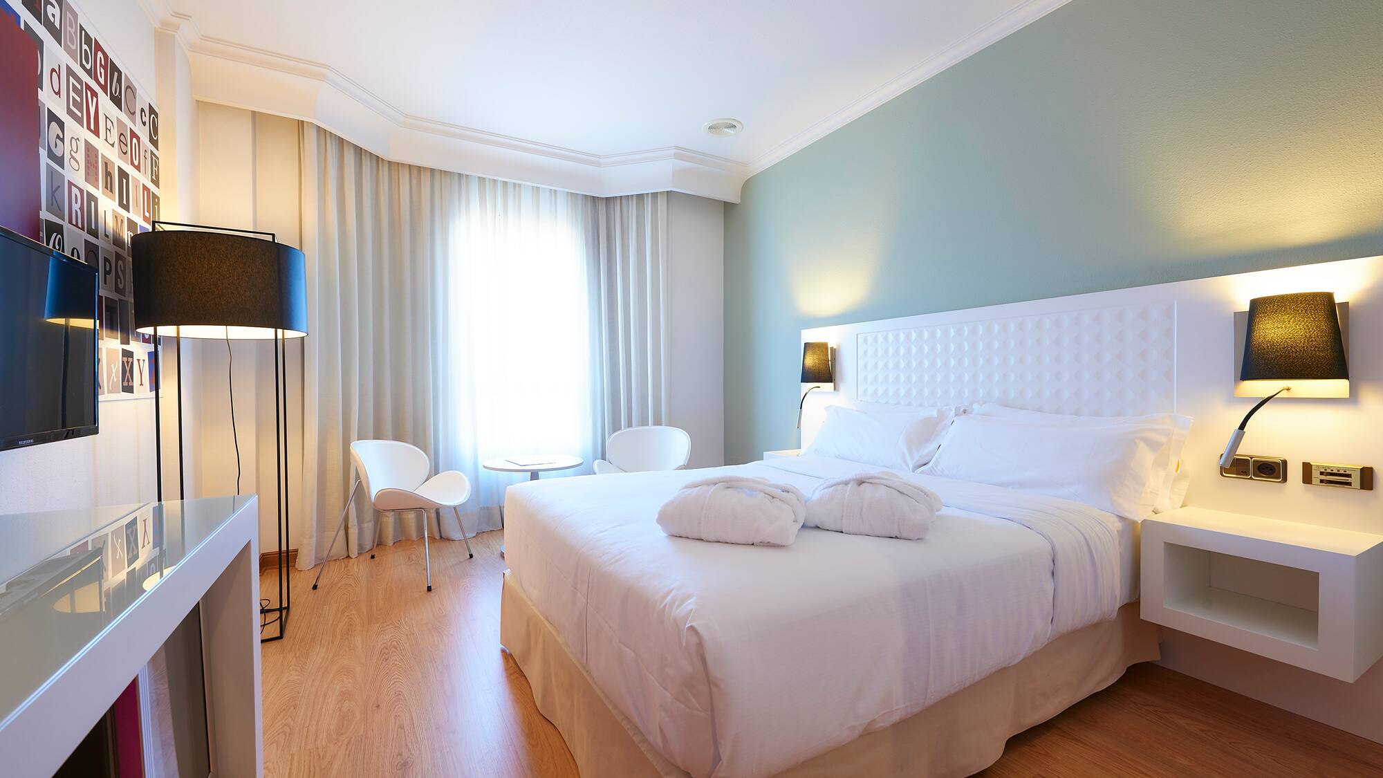 a bedroom with a bed and a table