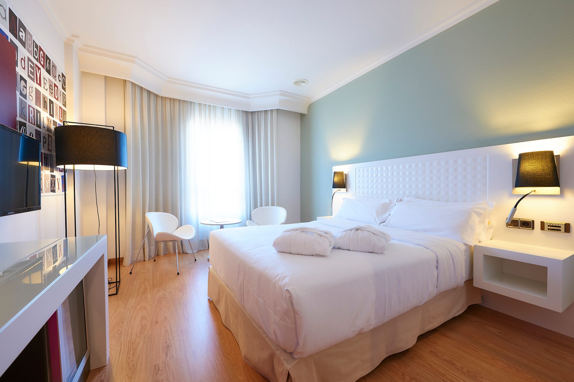 a bedroom with a bed and a table