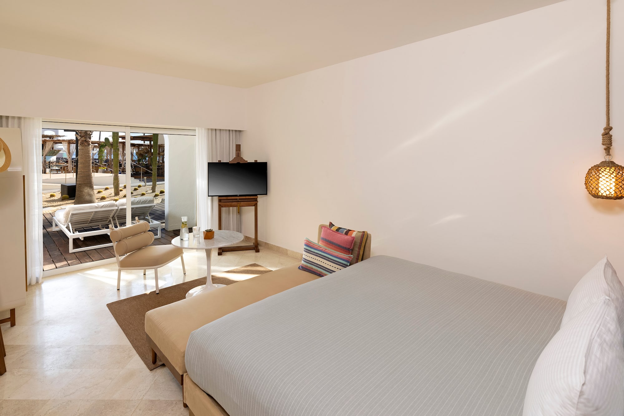 a room with a bed and a television