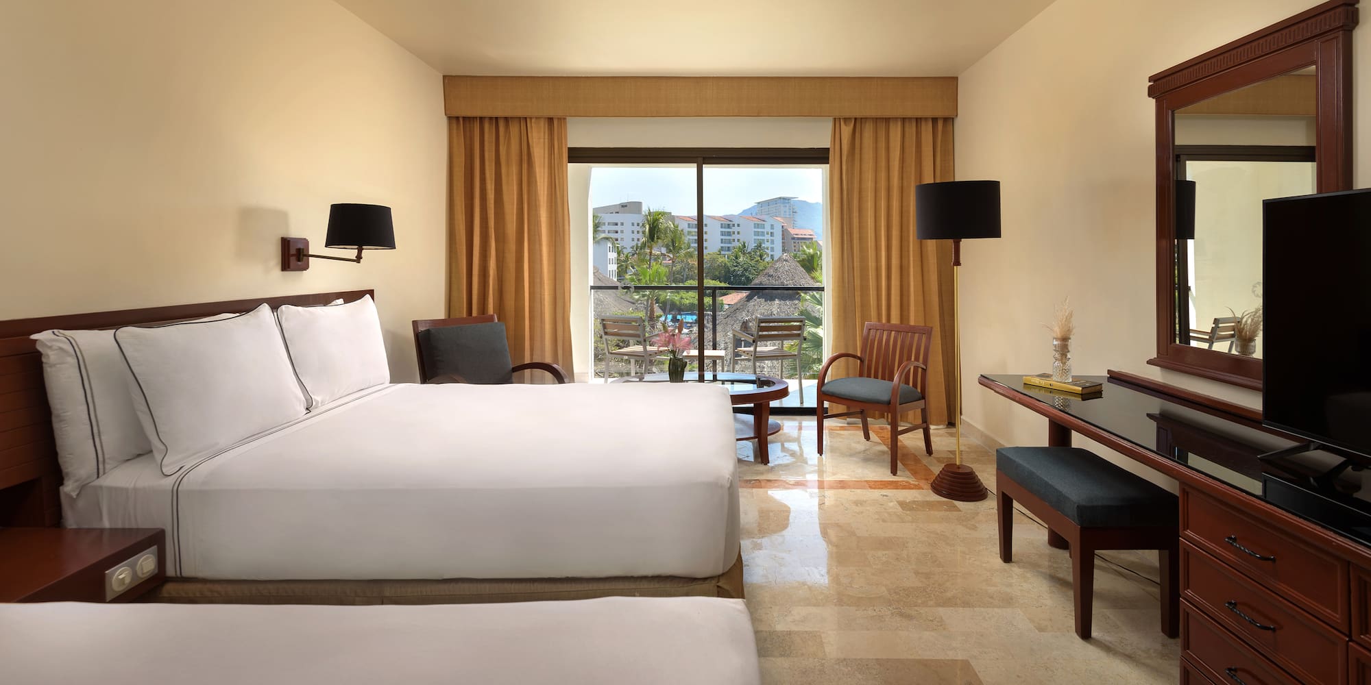 a room with a bed and chairs