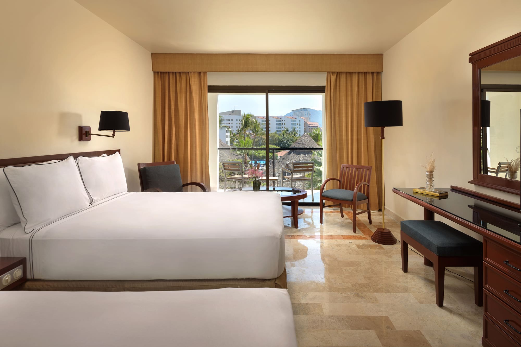 a room with a bed and chairs