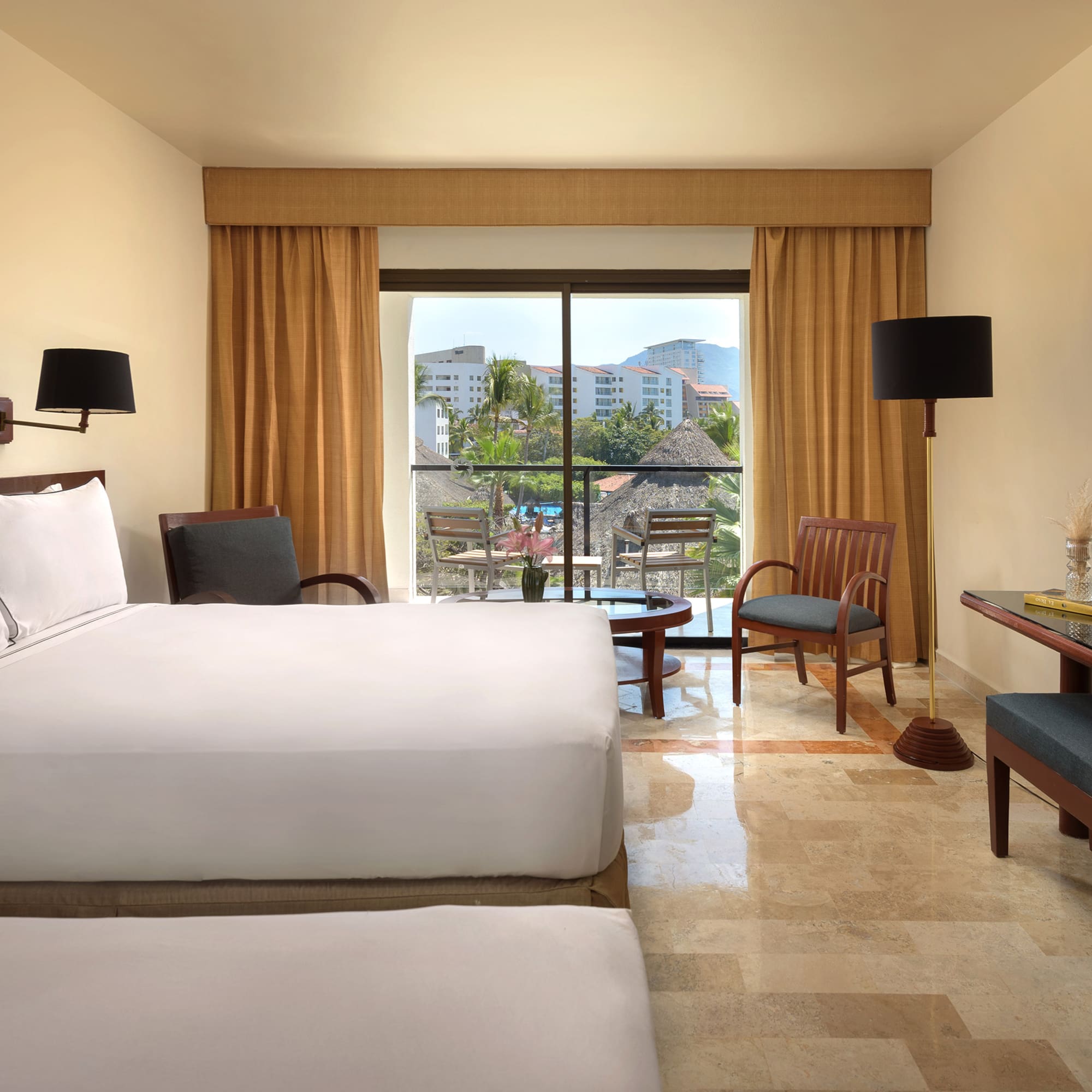 a room with a bed and chairs