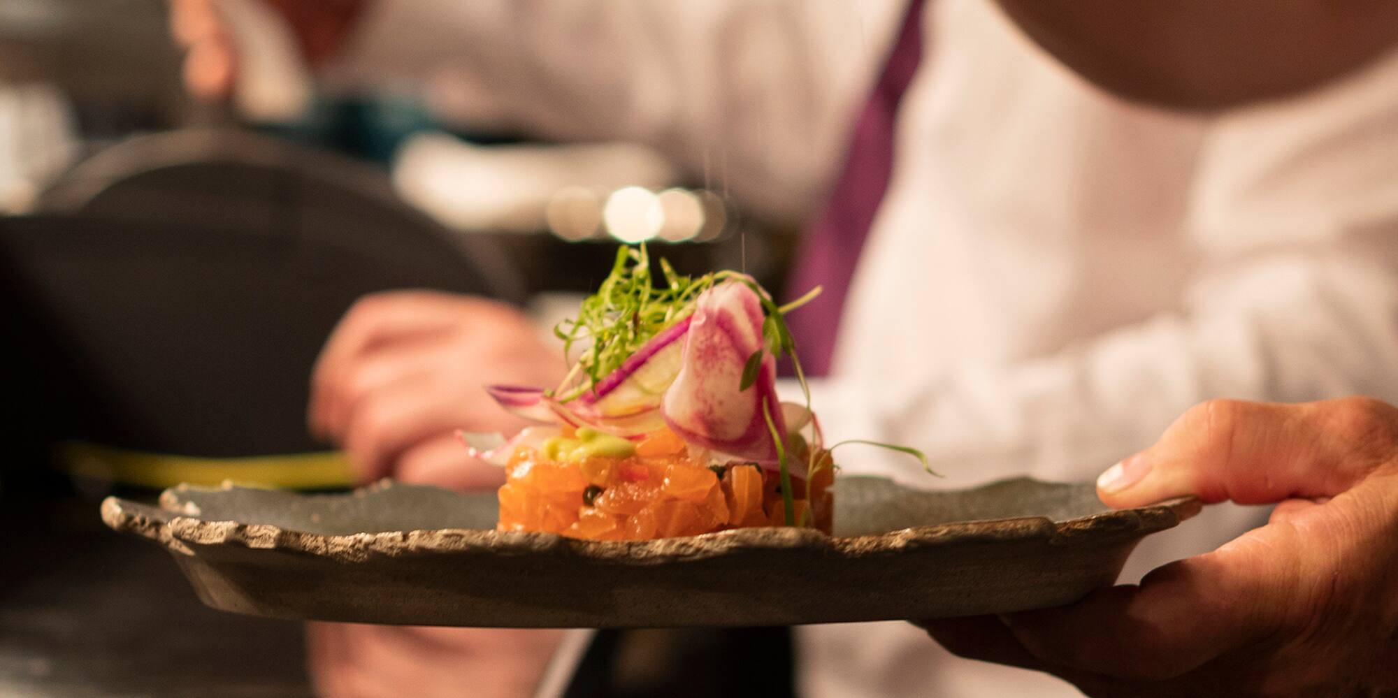 a person holding a plate of food