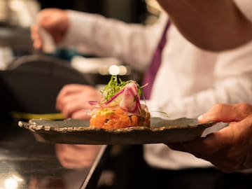 a person holding a plate of food