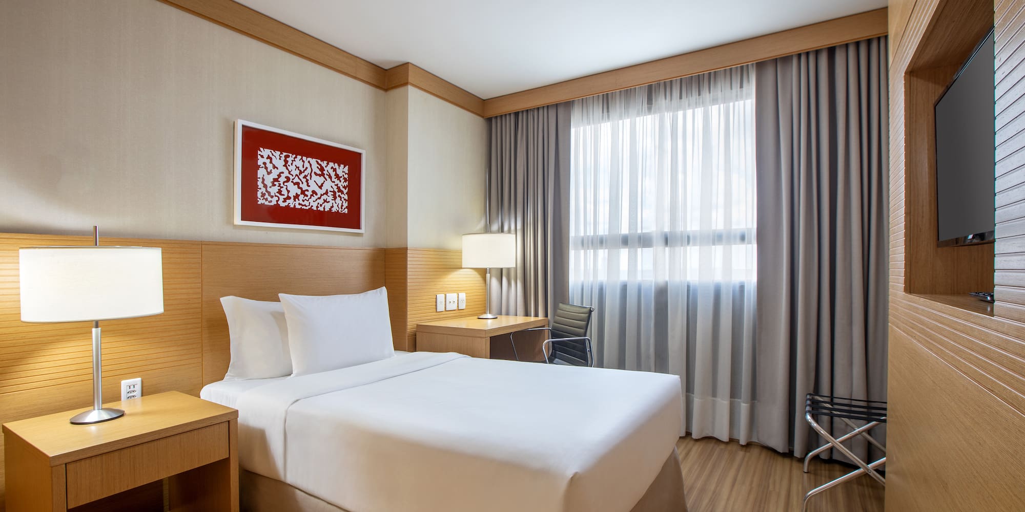 a room with a bed and a table and chairs