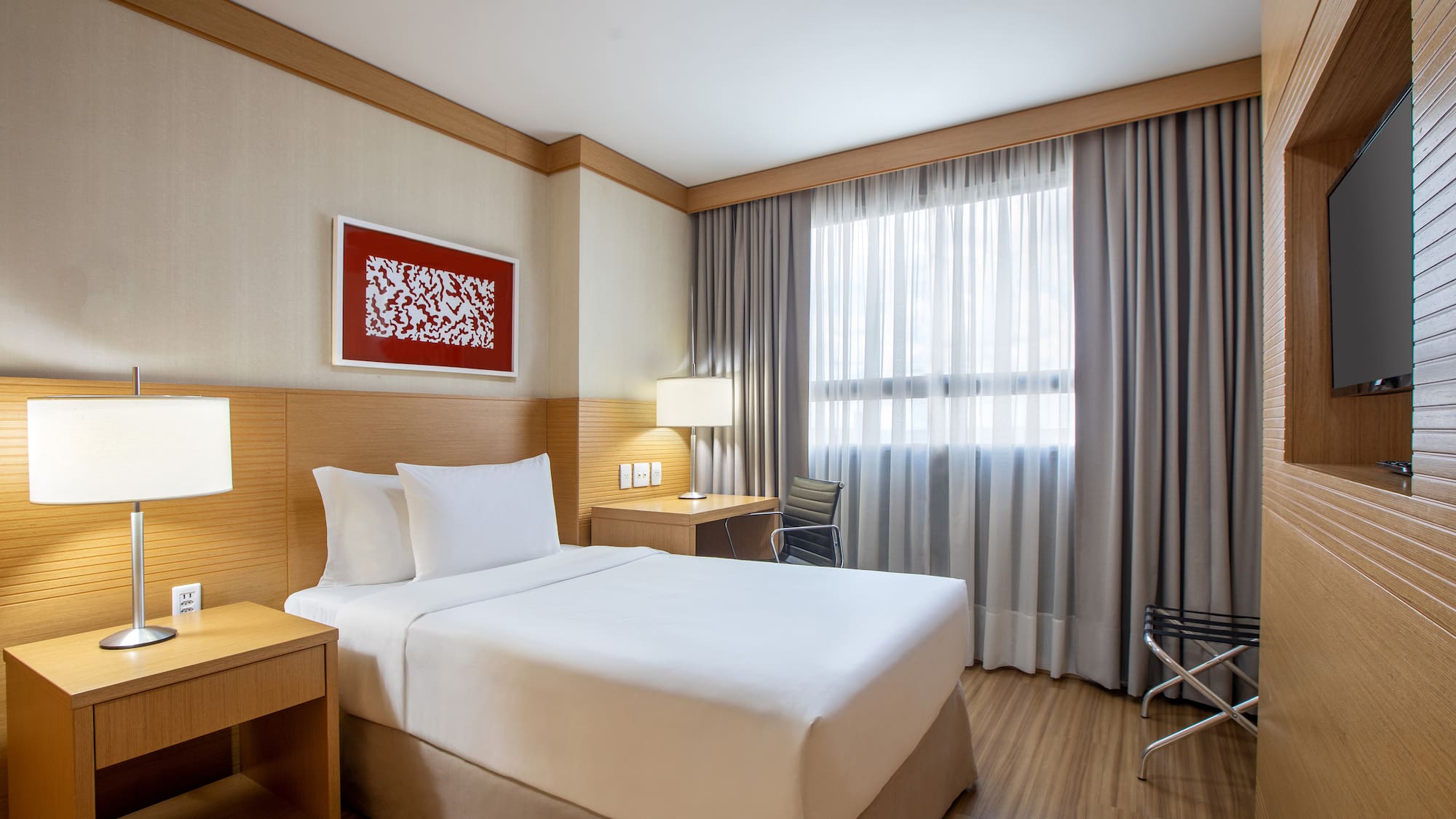 a room with a bed and a table and chairs