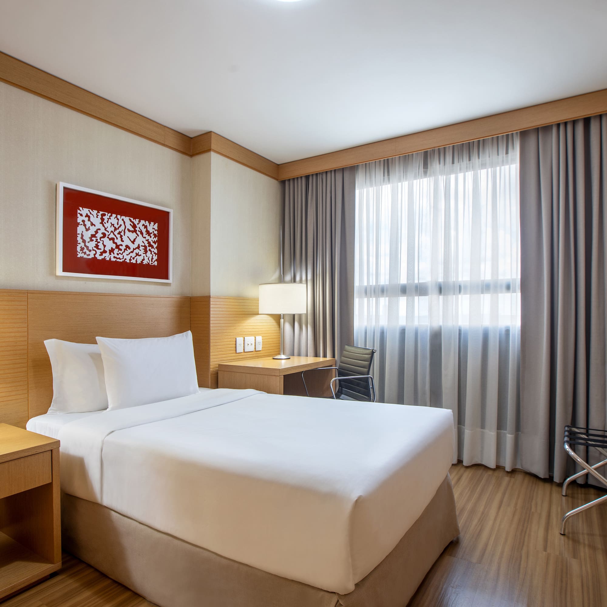 a room with a bed and a table and chairs