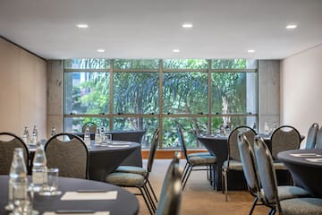 a room with round tables and chairs