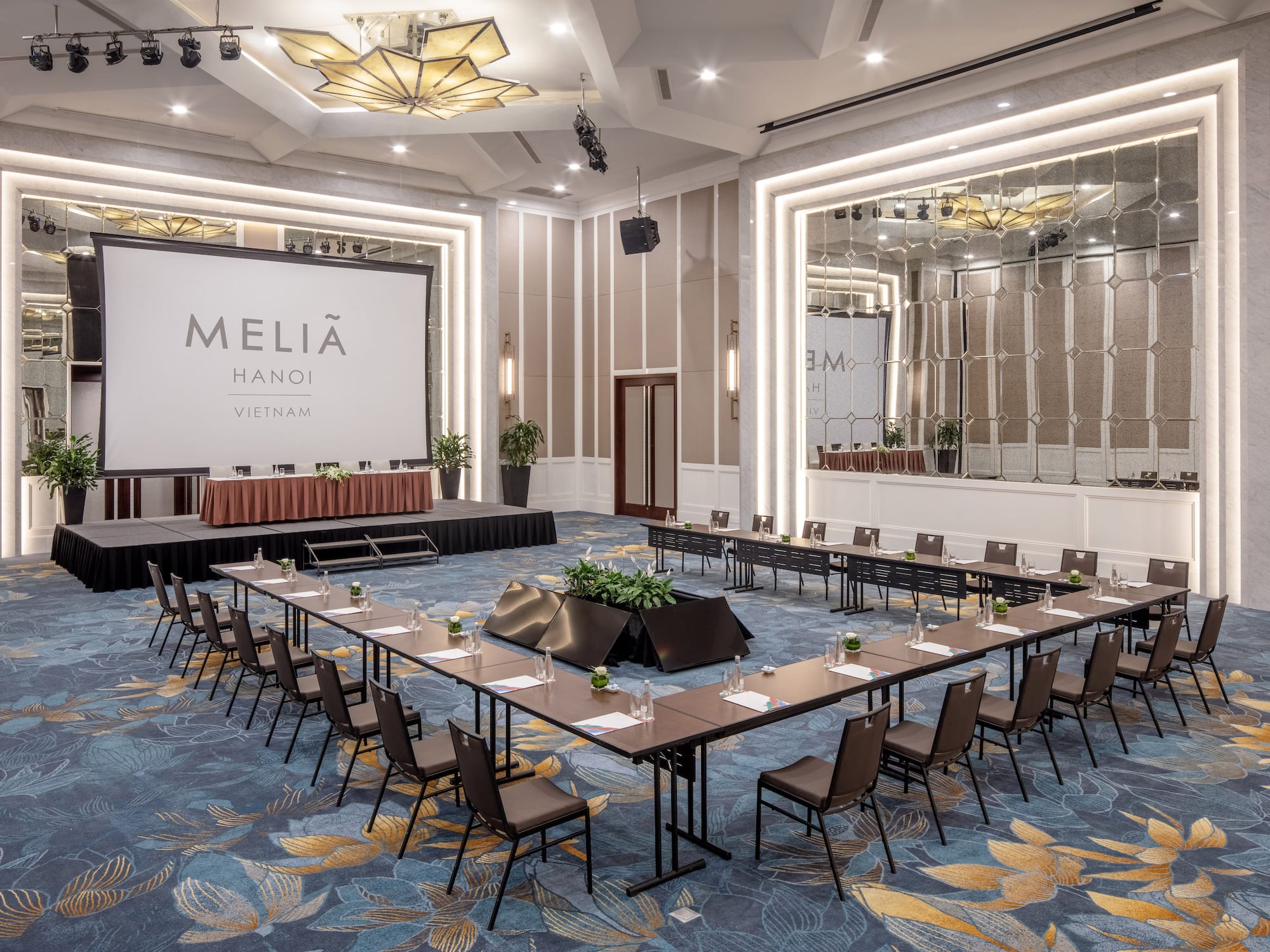 a room with a stage and tables