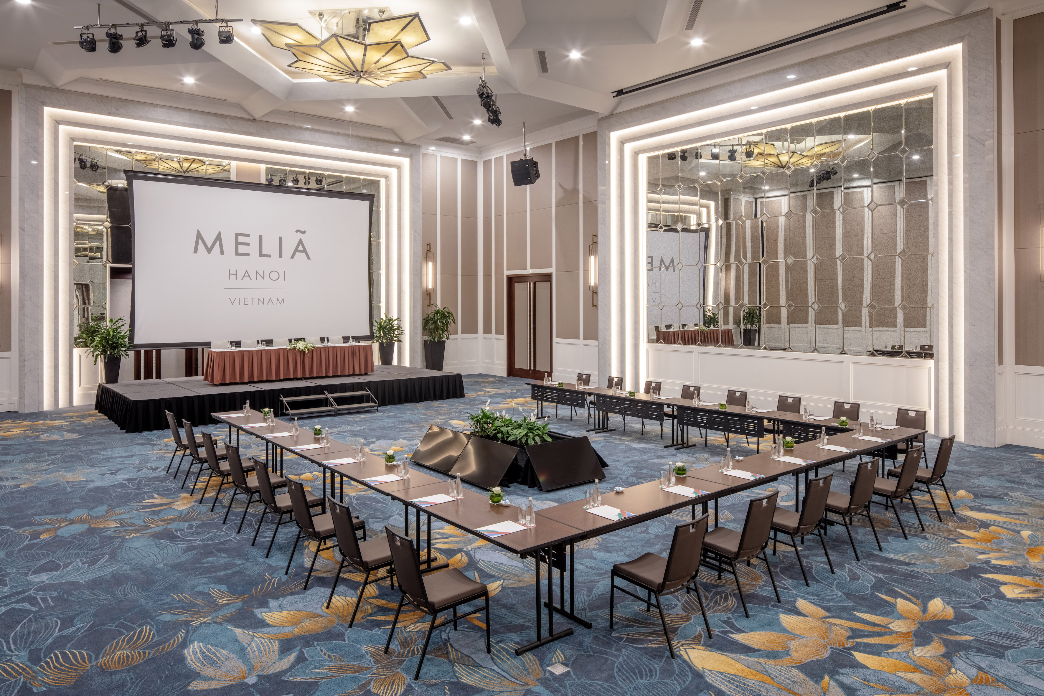 a room with a stage and tables