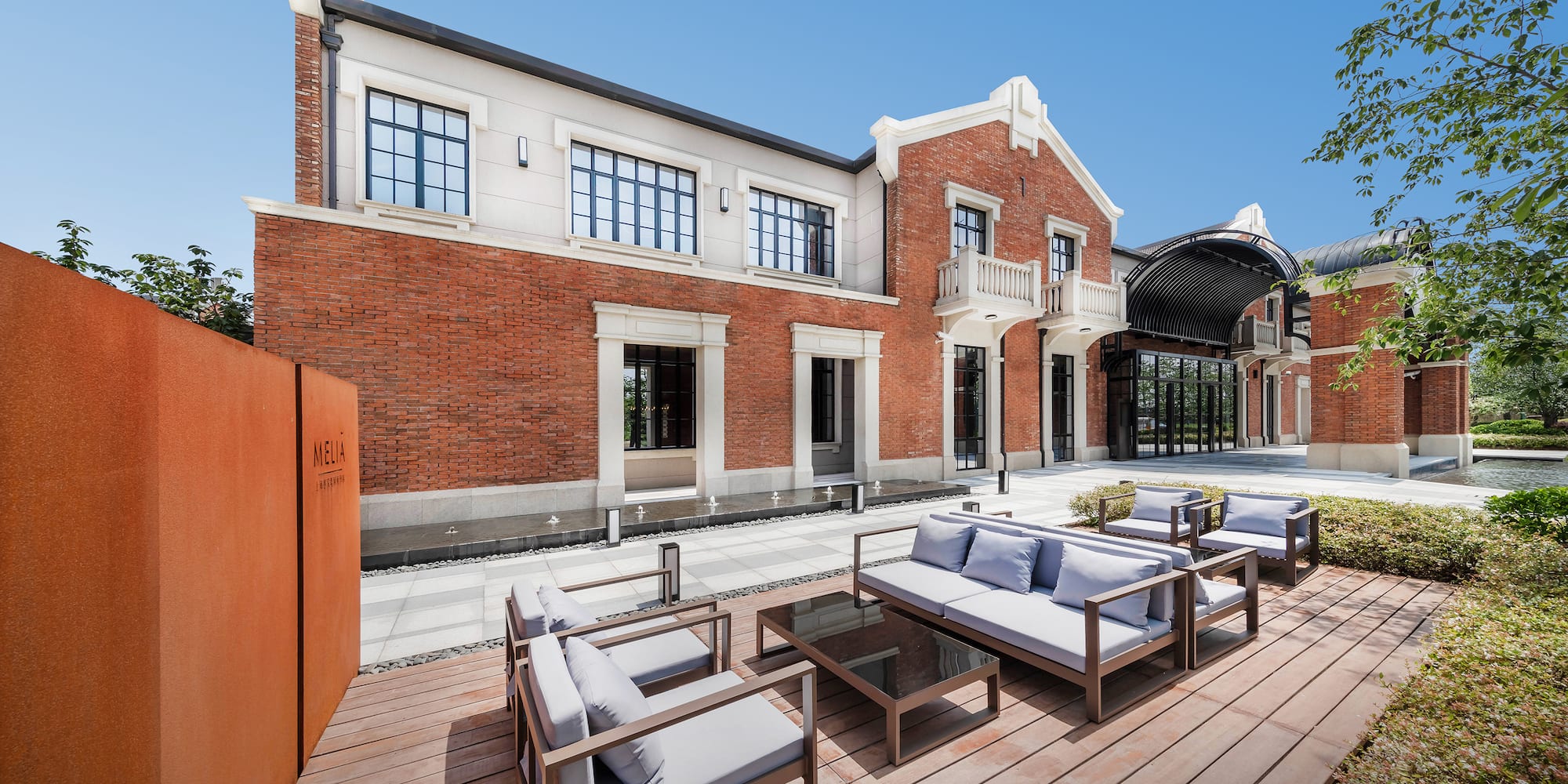 a patio with a brick building and a patio area