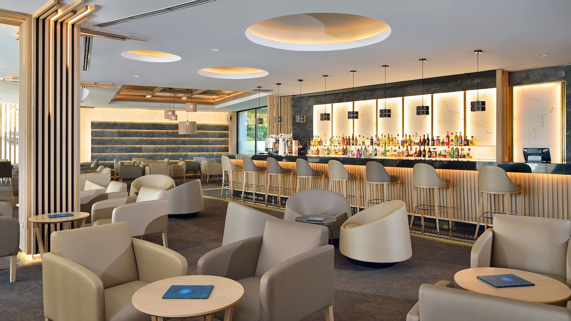 a room with a bar and chairs