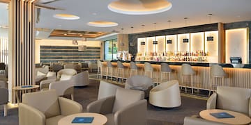 a room with a bar and chairs