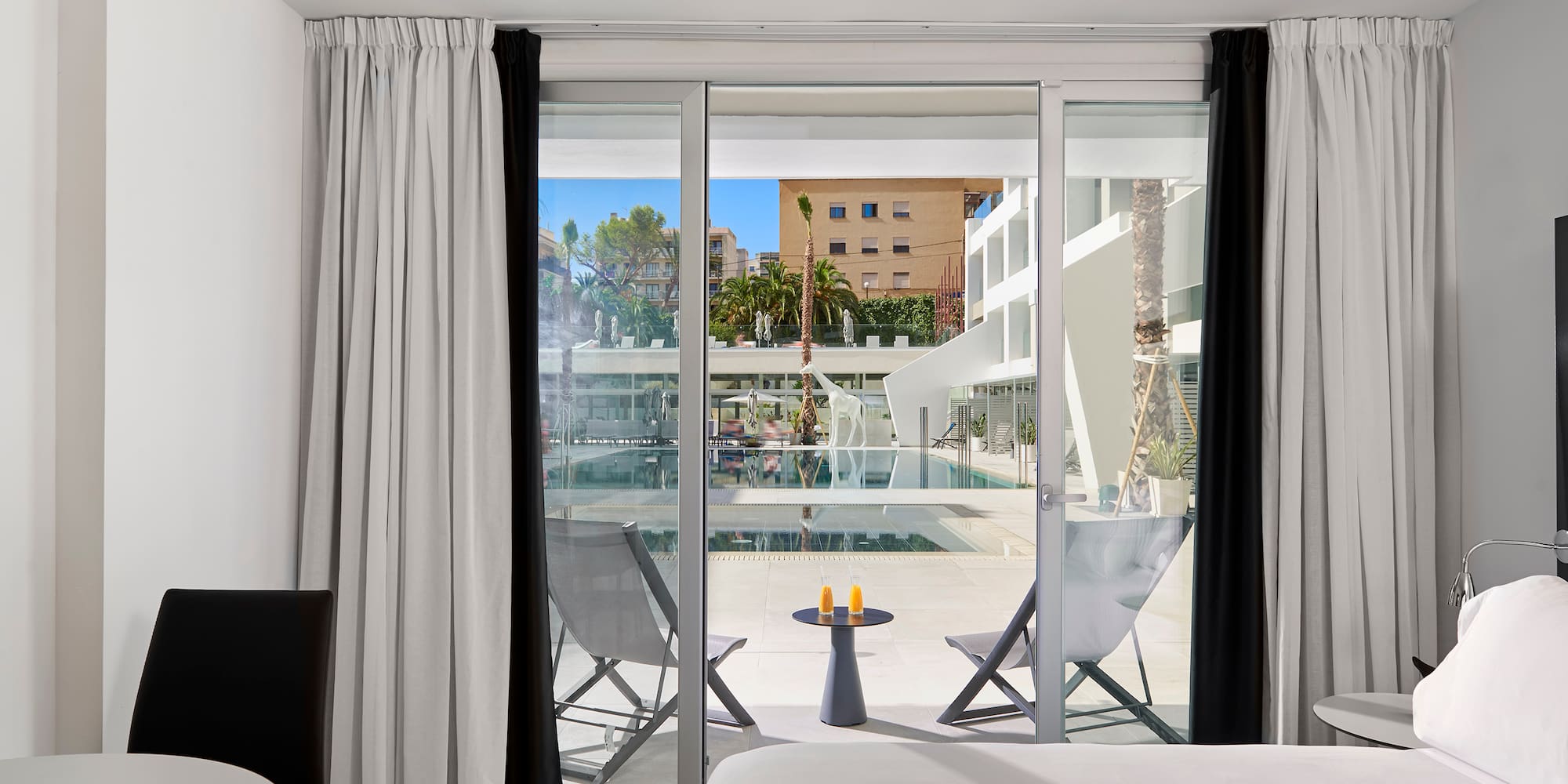 a room with a bed and a glass door