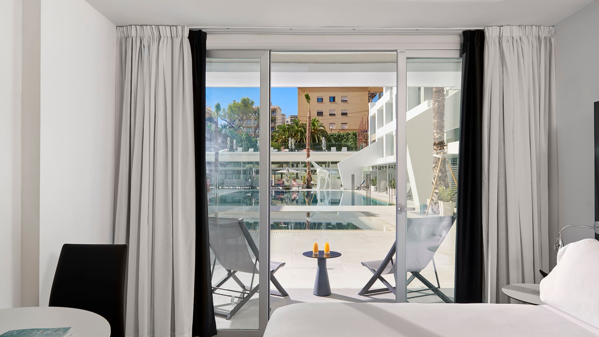 a room with a bed and a glass door