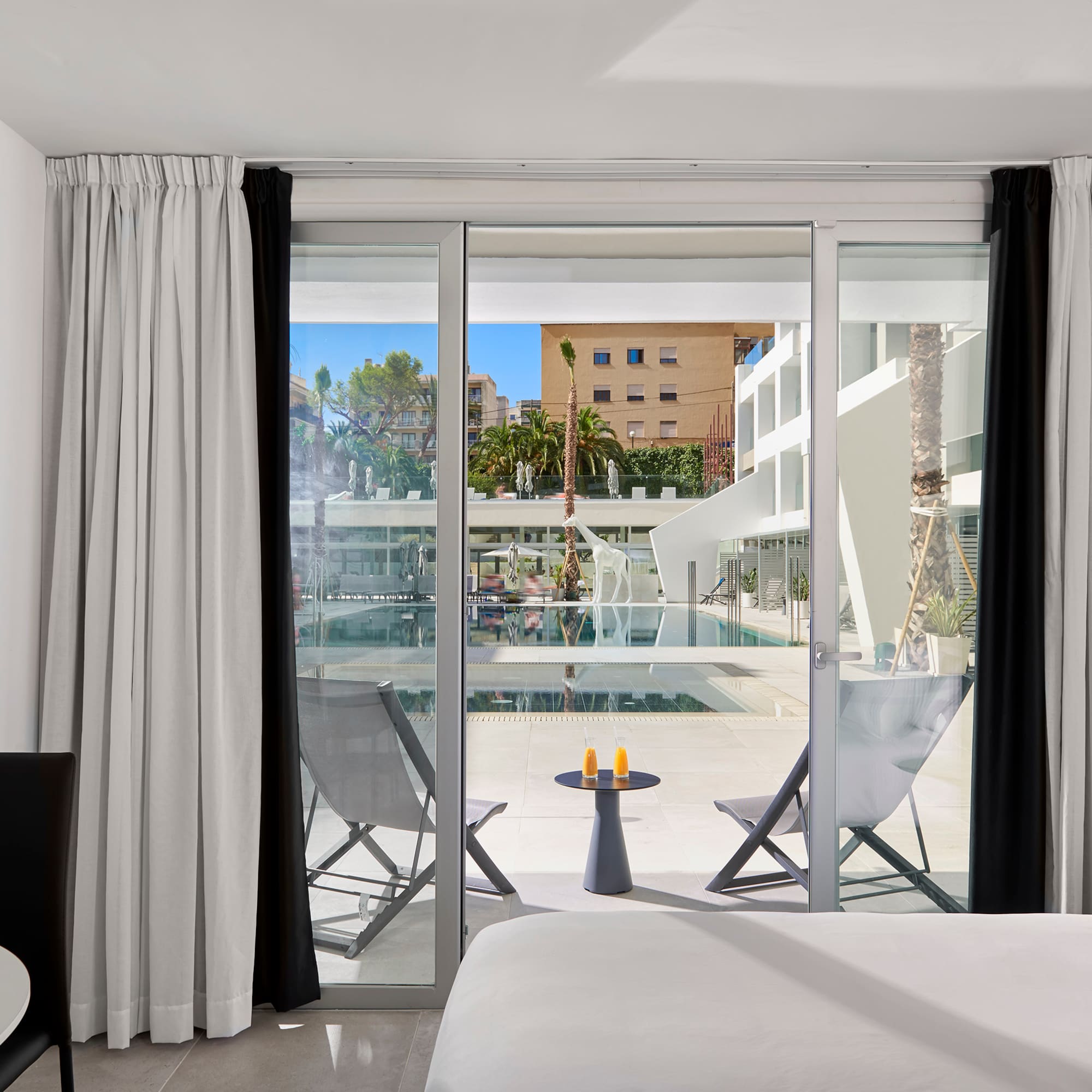 a room with a bed and a glass door