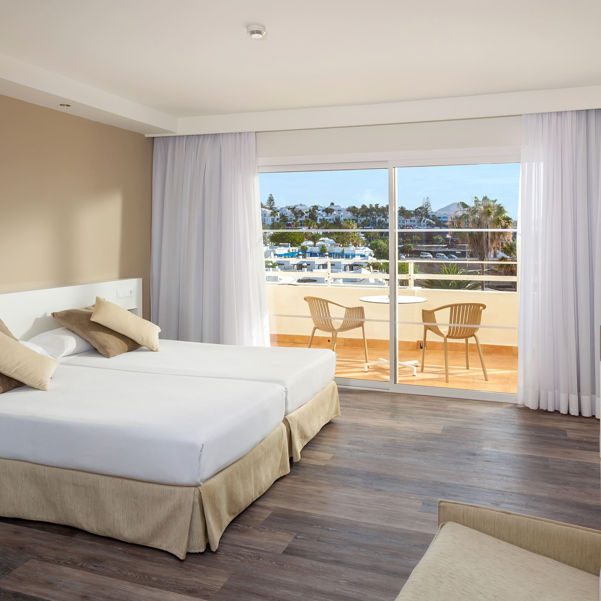 a room with two beds and a glass door