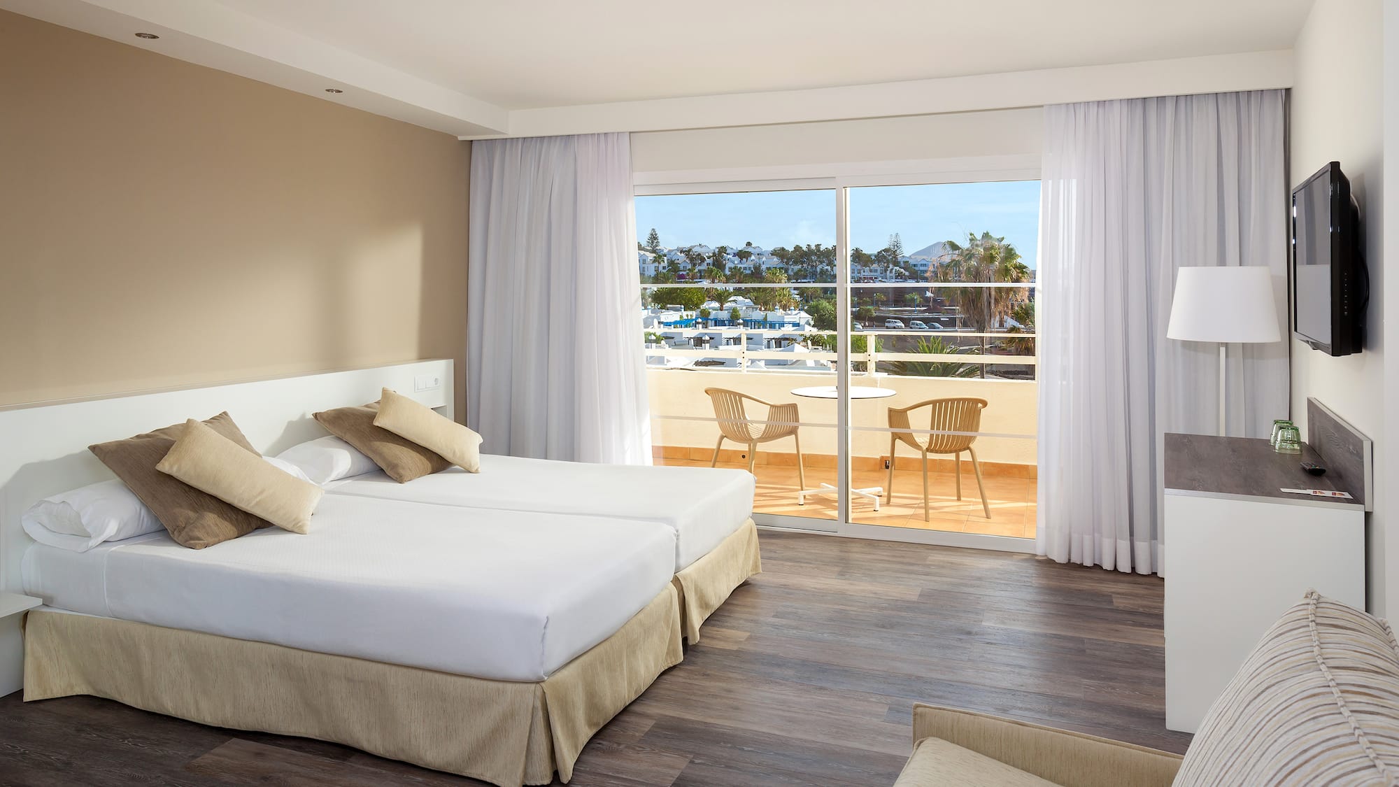 a room with two beds and a glass door