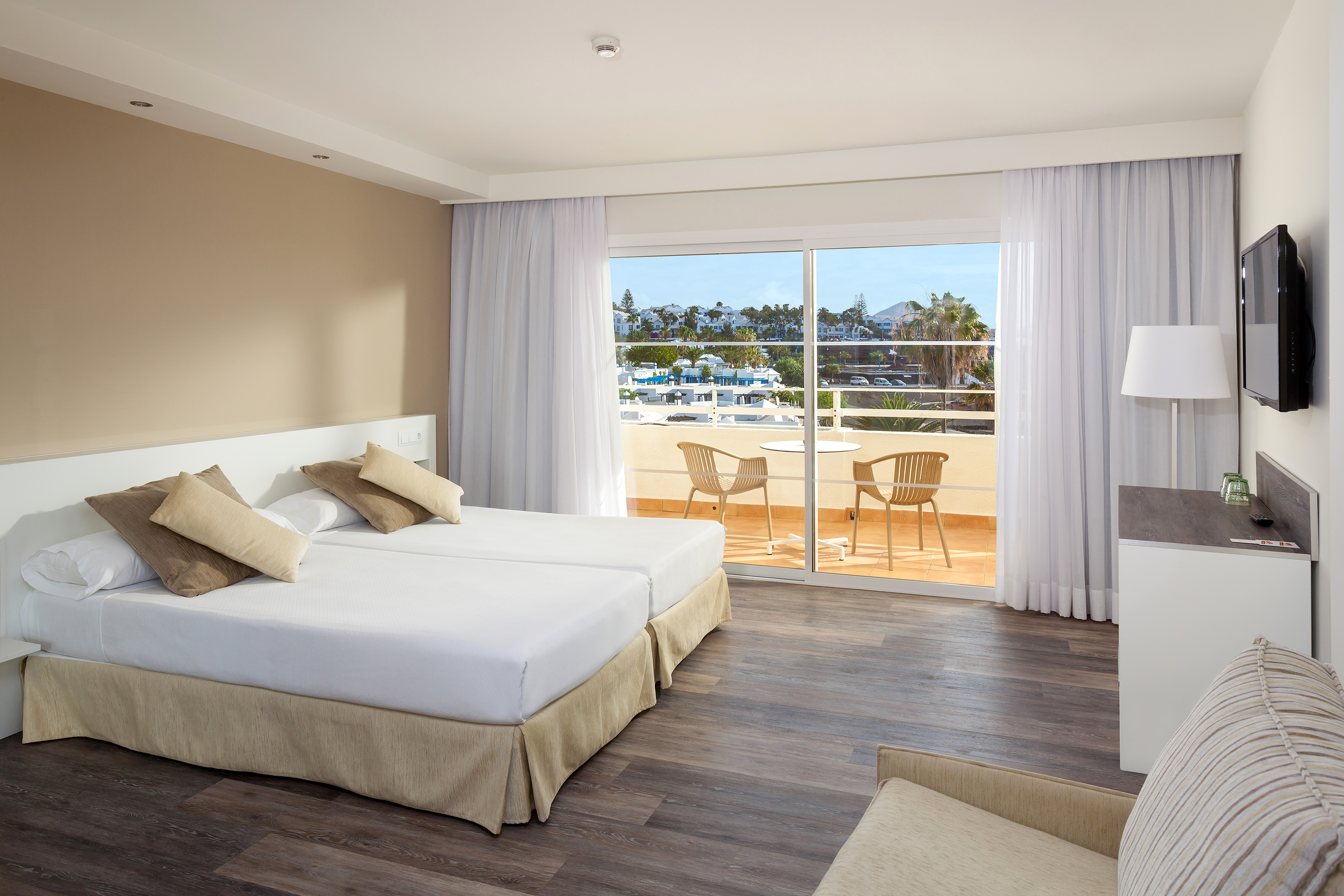 a room with two beds and a glass door