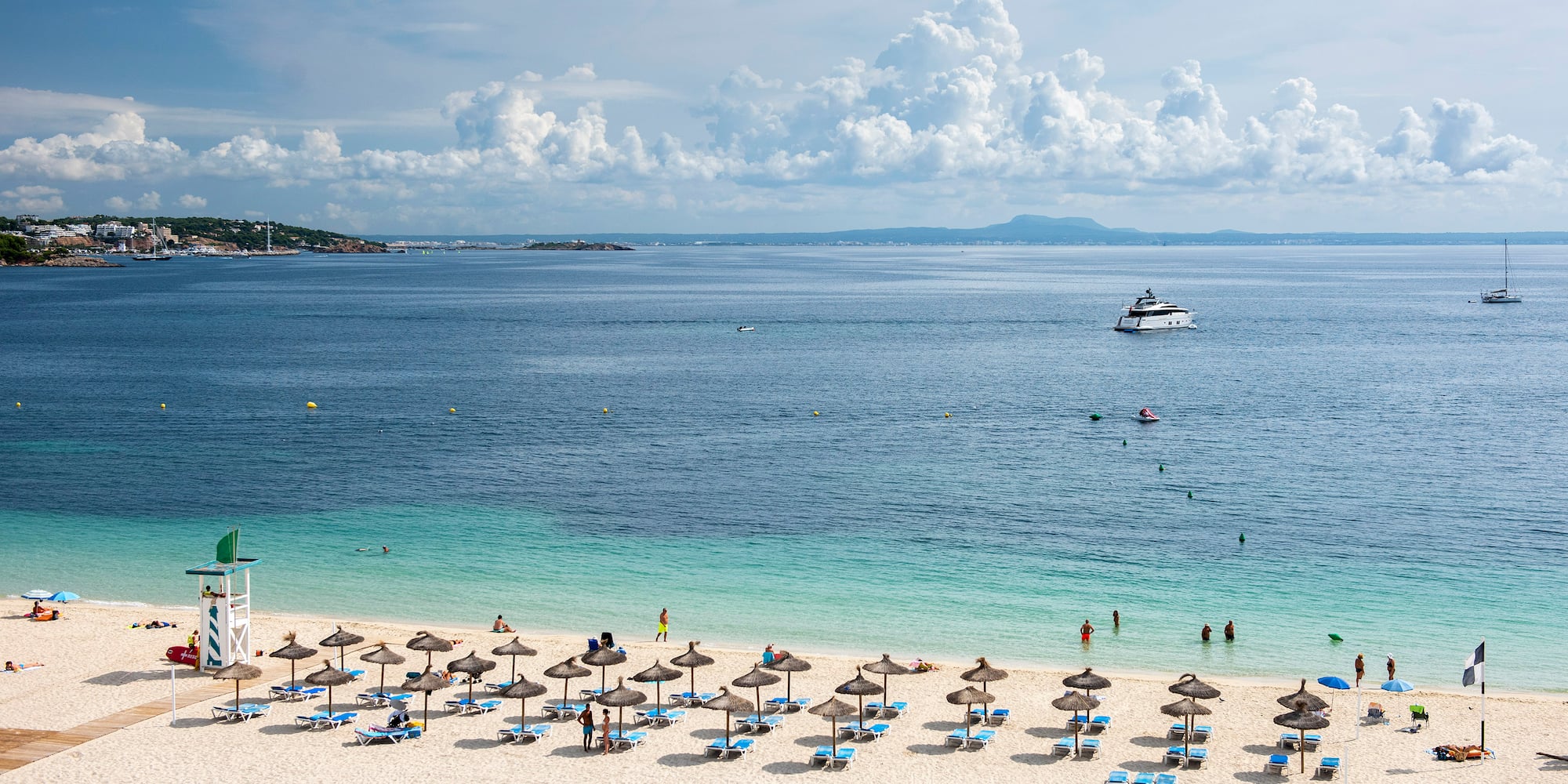 a beach with umbrellas and chairs