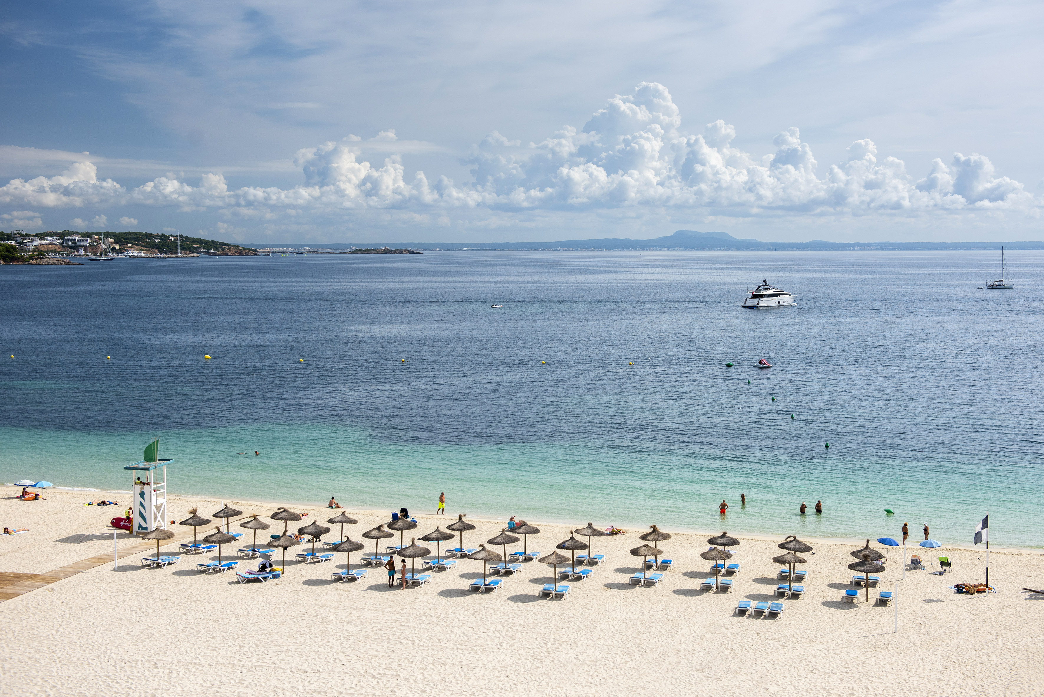 a beach with umbrellas and chairs