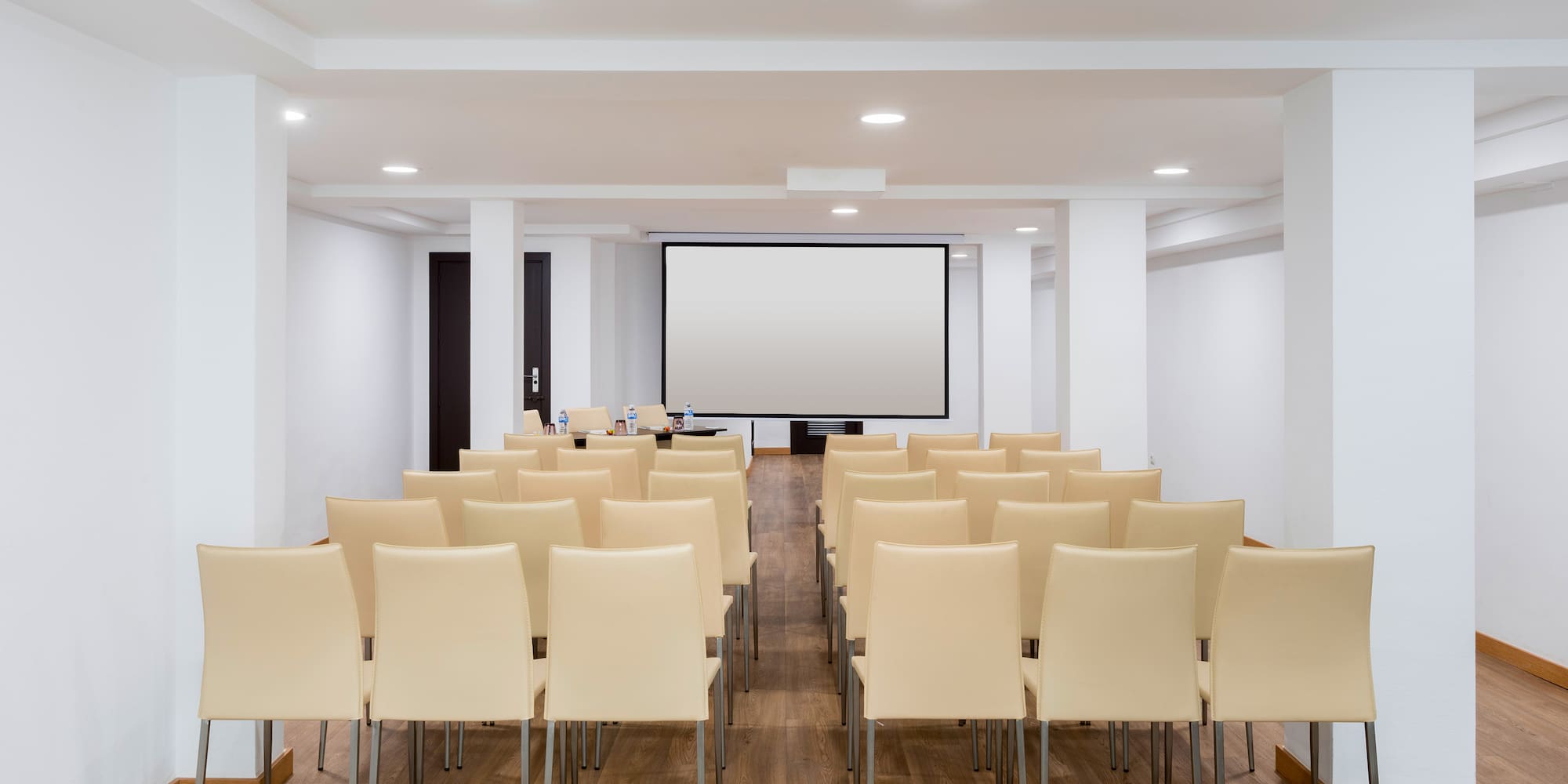 a room with chairs and a projector screen