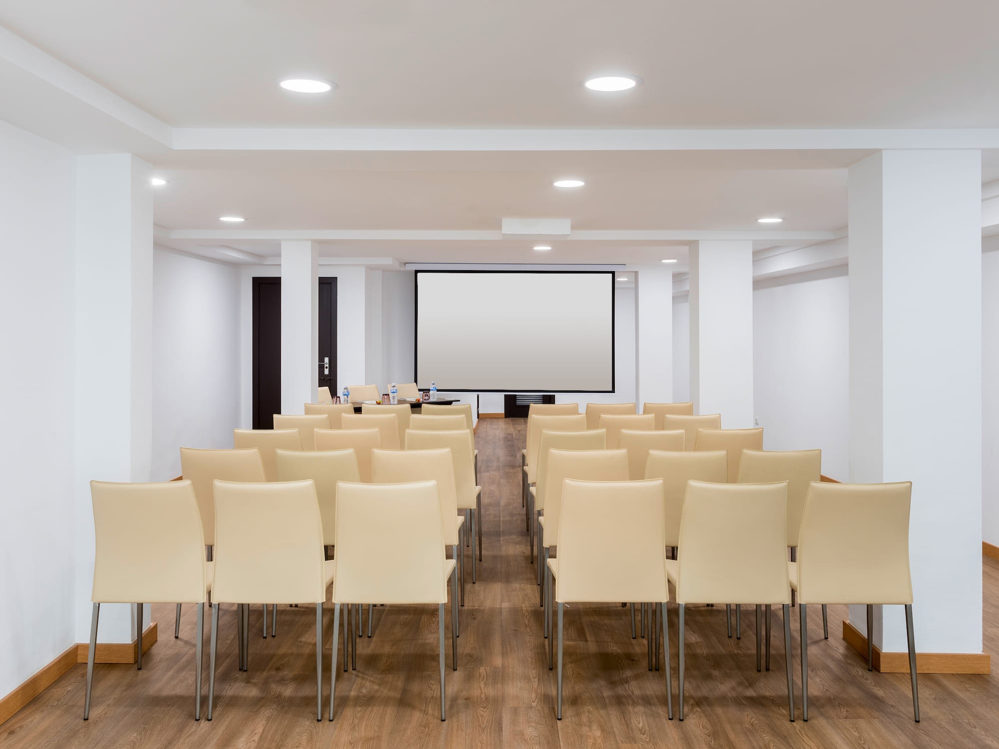 a room with chairs and a projector screen