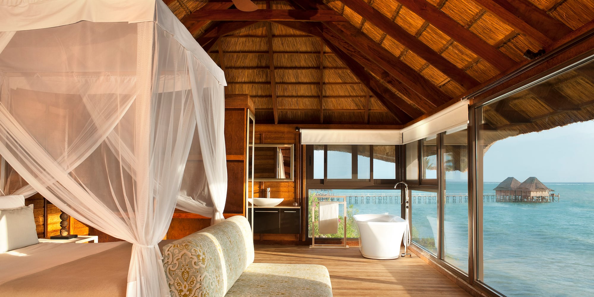 a room with a bed and a tub and a tub