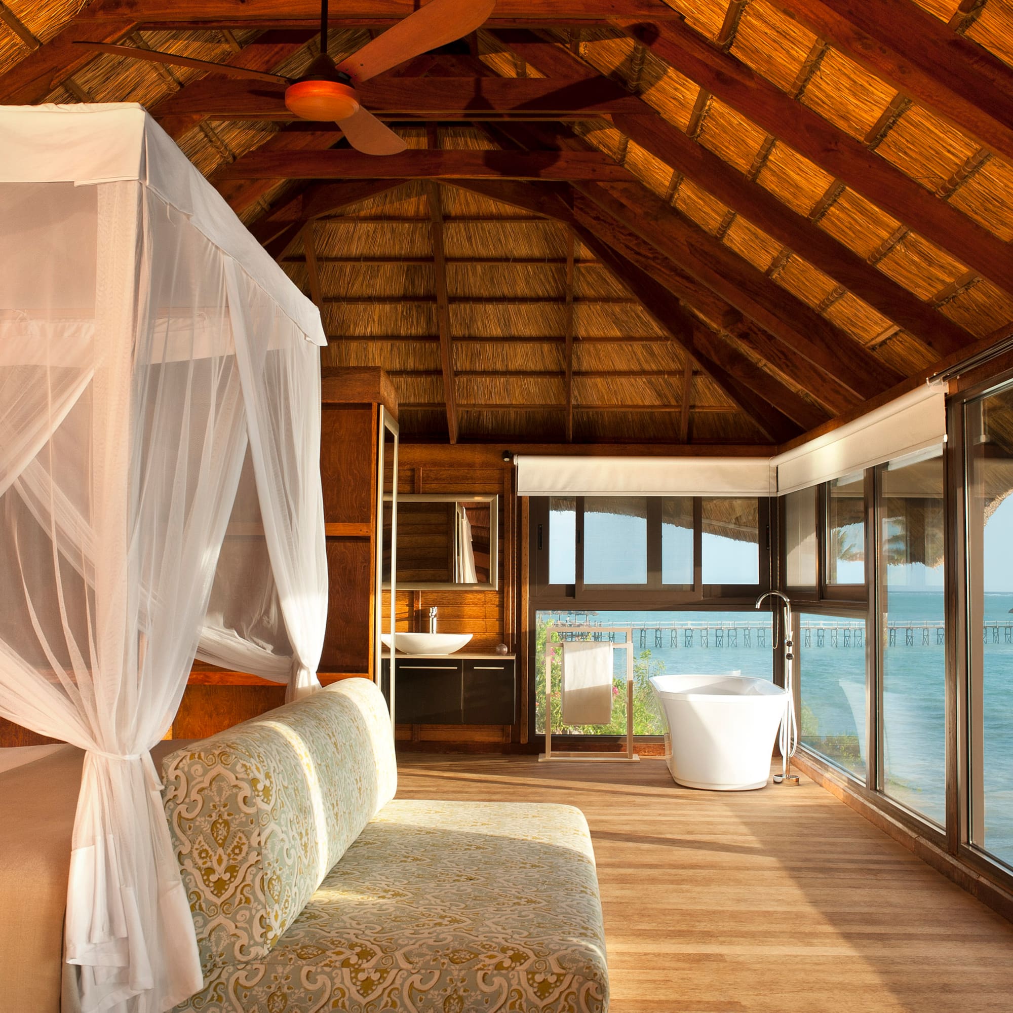 a room with a bed and a tub and a tub