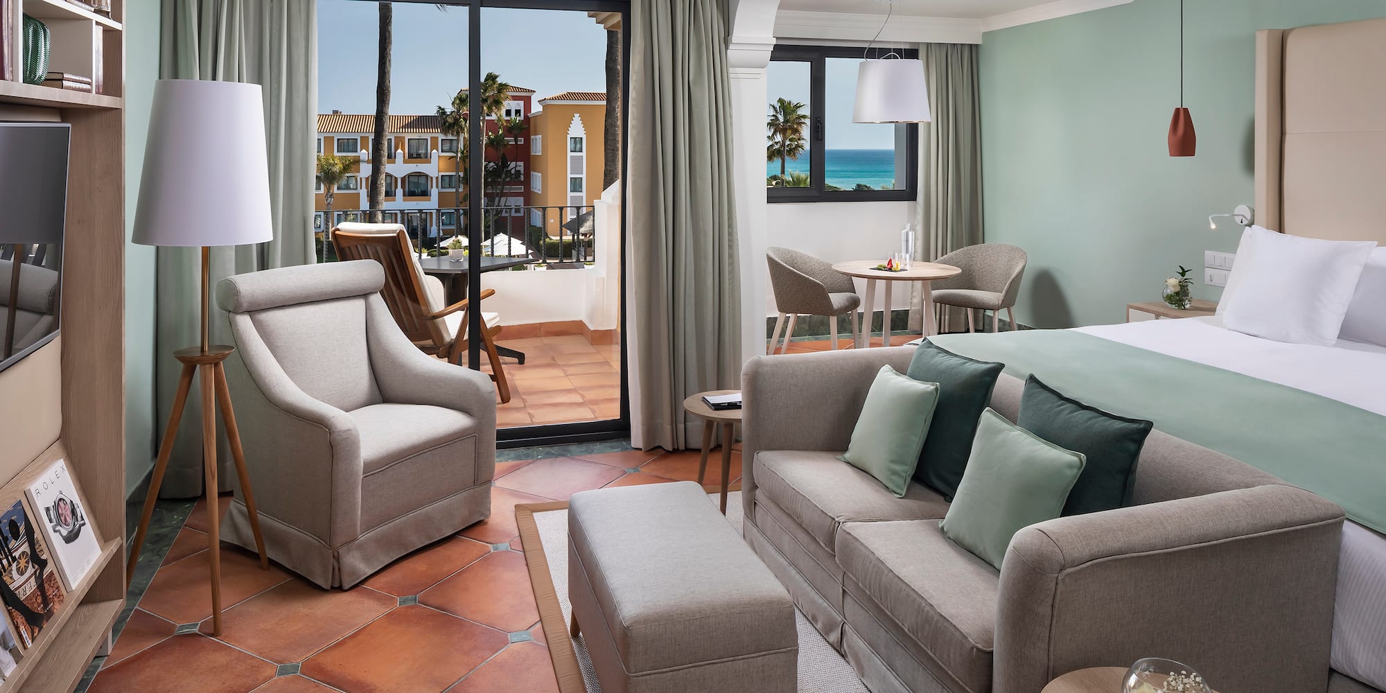 a room with a bed and chairs and a table