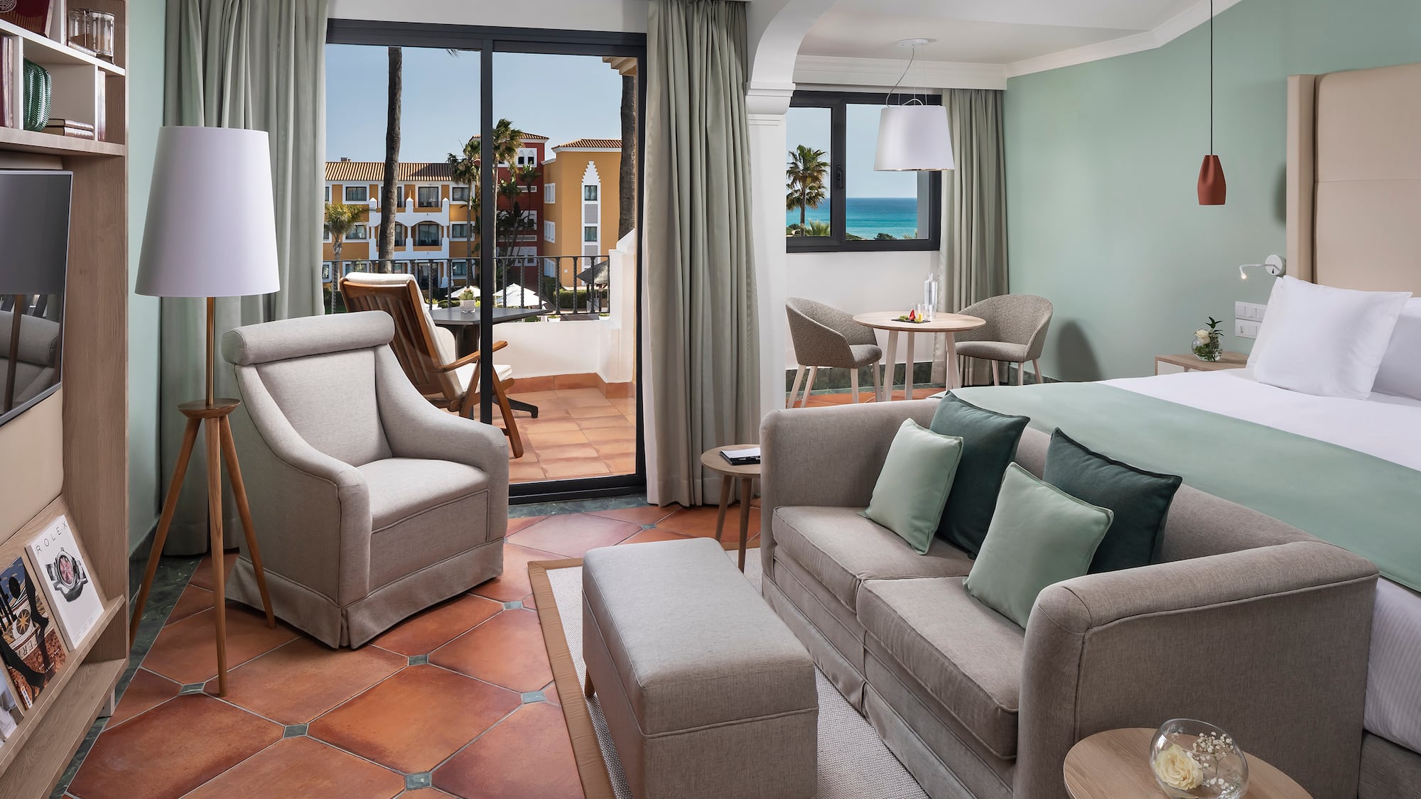 a room with a bed and chairs and a table