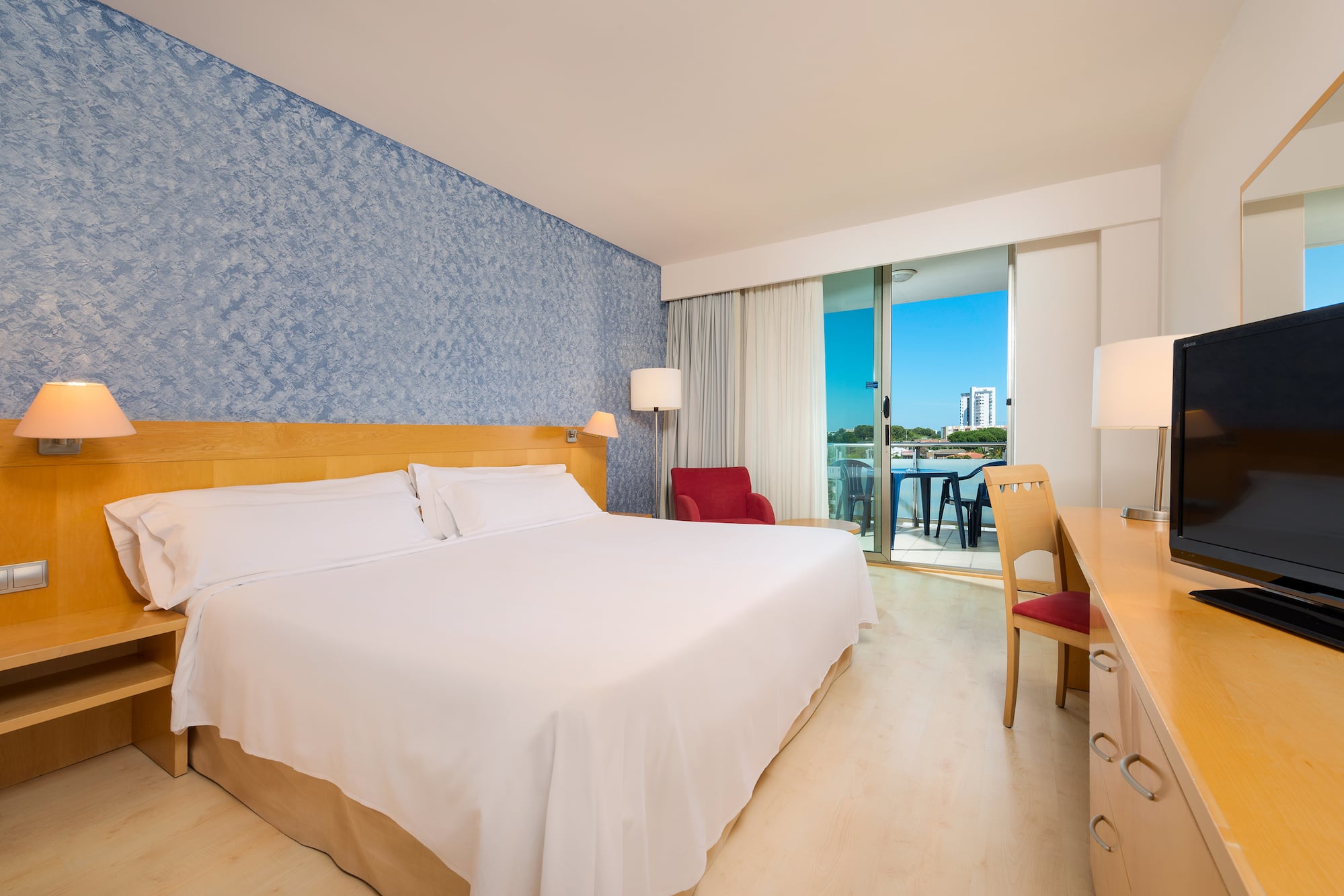 a room with a bed and a table and chairs