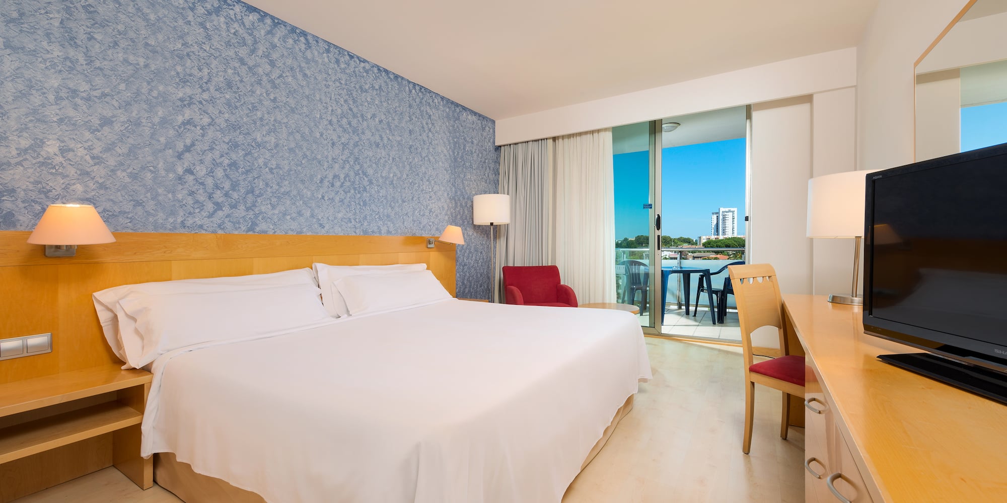 a room with a bed and a table and chairs