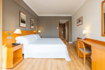 a room with a bed and a desk