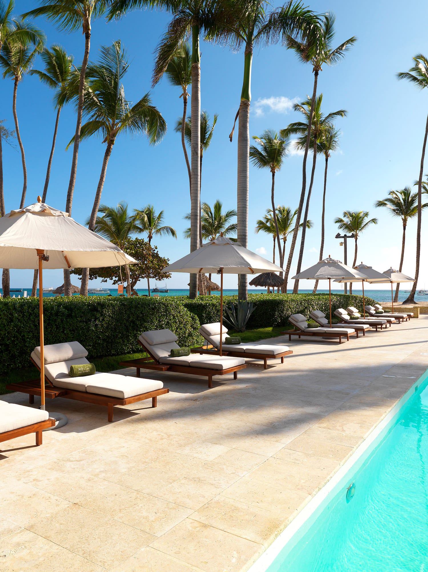 a pool with lounge chairs and umbrellas