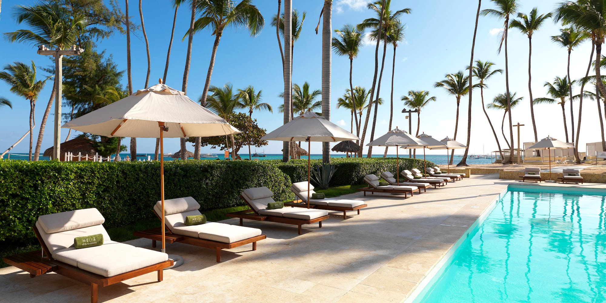 a pool with lounge chairs and umbrellas